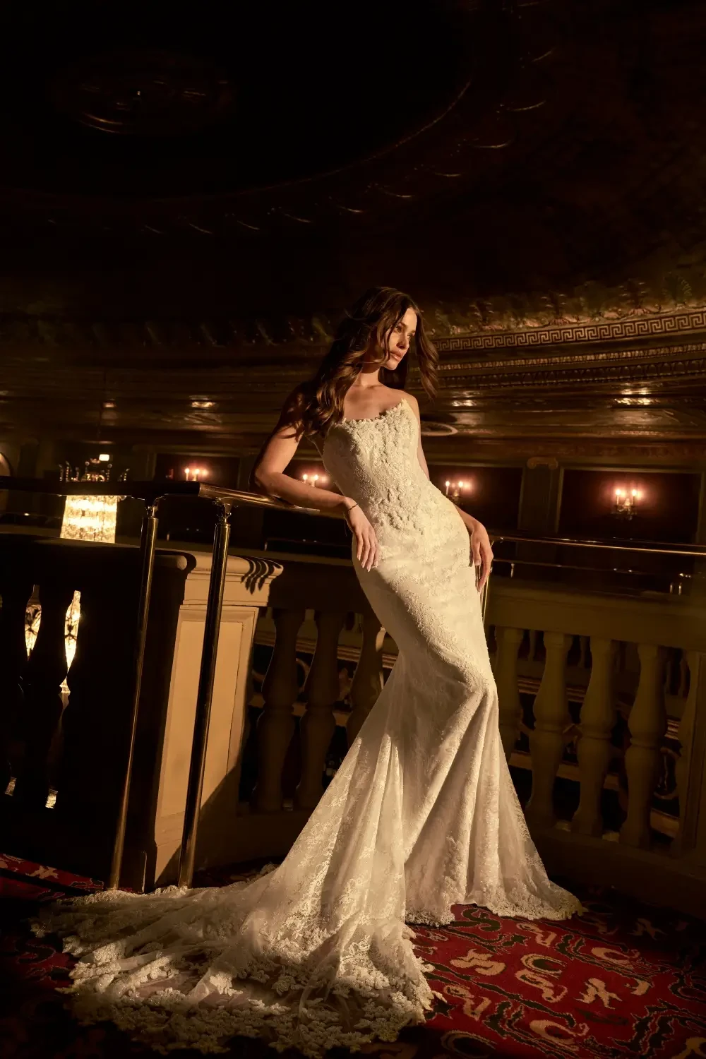 model is wearing a strapless fit and flare bridal gown