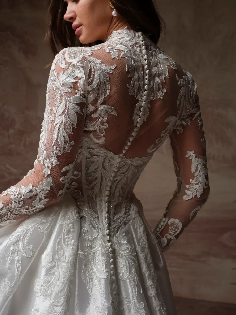 model is wearing a high neckline lace bridal gown