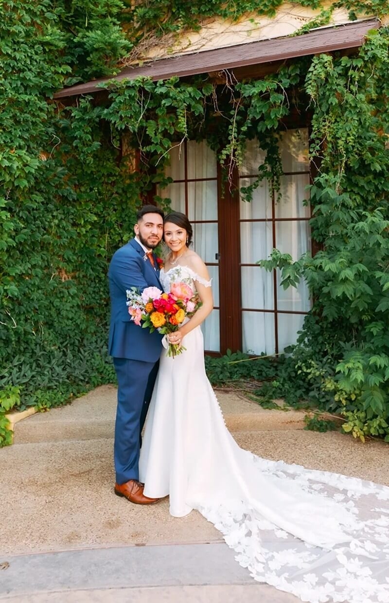 Сouple wearing a white gown and a blue suit