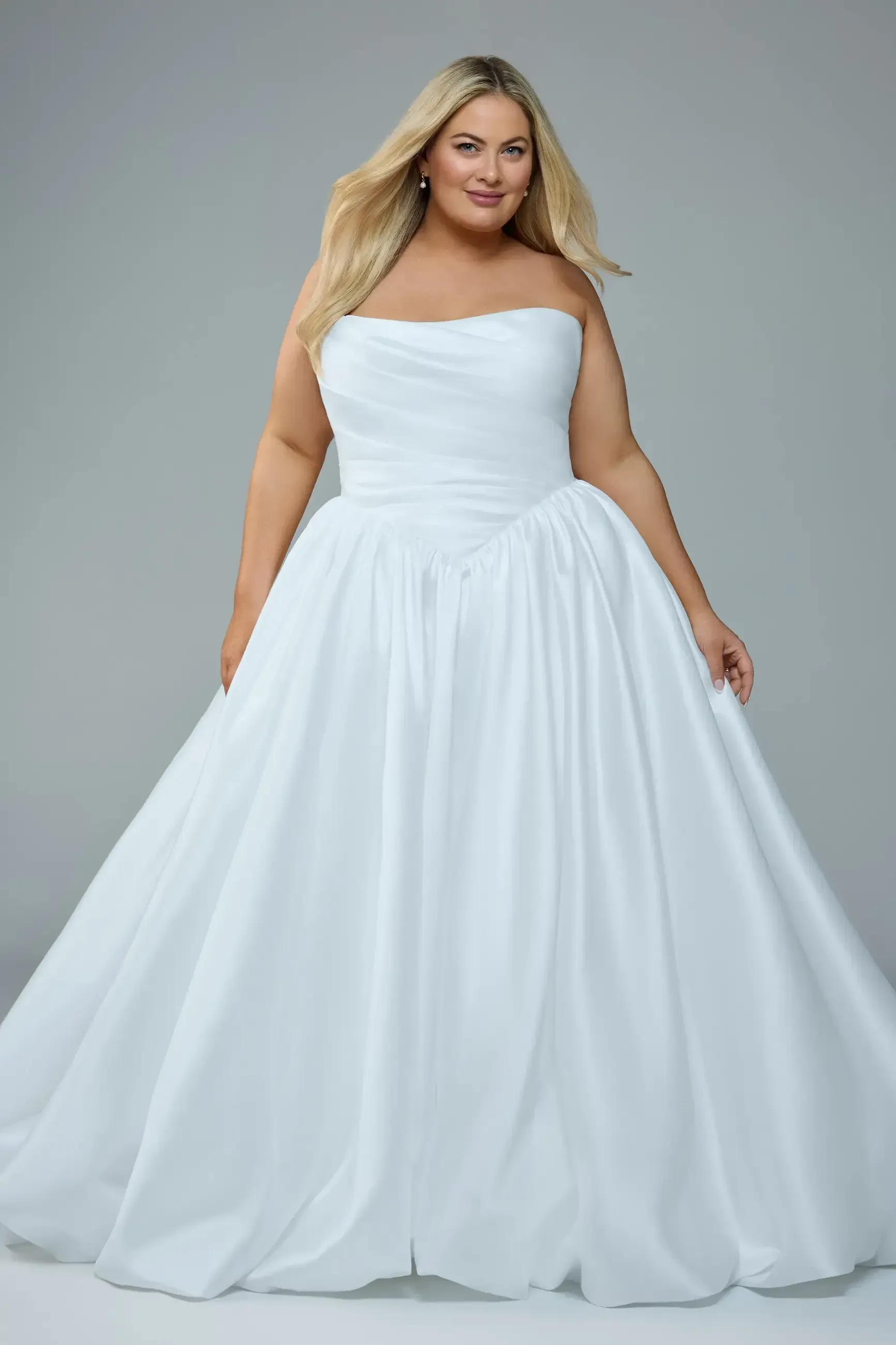 A woman in a strapless, white ball gown.